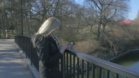 Woman using her smartphone Stock Footage 61363524