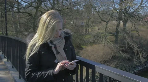 Woman using her smartphone Stock Footage 61363533