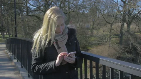 Woman using her smartphone Stock Footage 61363570