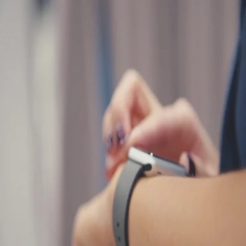 Woman using her smartwatch touchscreen wearable technology device Stock Footage