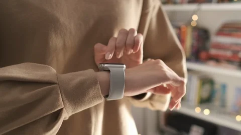 Woman using her smartwatch touchscreen technology device Stock Footage 123971440