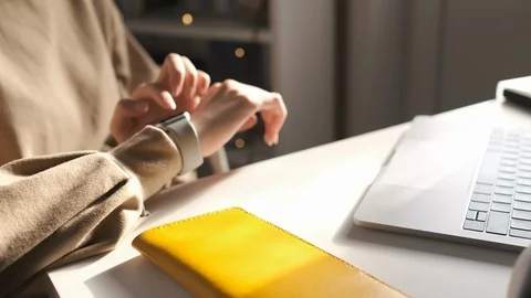 Woman using her smartwatch touchscreen technology device Stock Footage 123971499