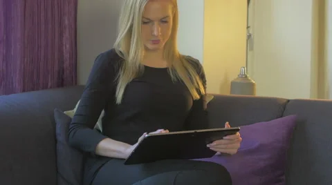Woman using her tablet Stock Footage 61363433