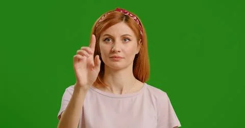 Woman using interactive touch screen with various gestures isolated green b.. Stock Photos