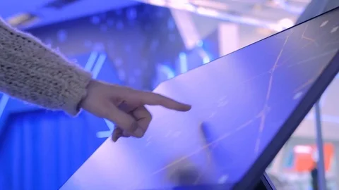 Woman using interactive touchscreen display at modern technology exhibition Stock Footage 84570305