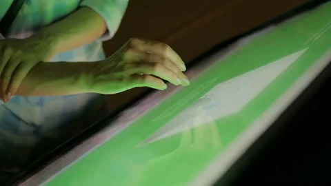 Woman using interactive touchscreen display at modern museum Stock Footage 97707631