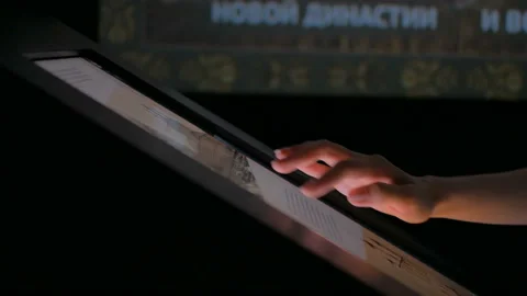 Woman using interactive touchscreen display at modern history museum Stock Footage 109624123