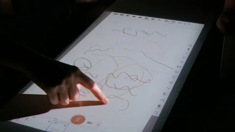Woman using interactive touchscreen projector display for drawing at exhibition Stock Footage 96739003