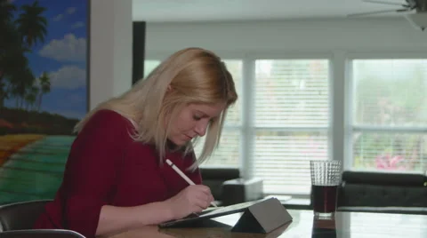 Woman Using iPad Pro in Kitchen Video stock 59734023