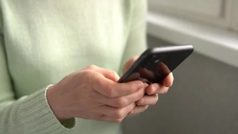 Woman using iPhone 11 smartphone pressing finger, reading internet, typing text Stock-Footage 234916927