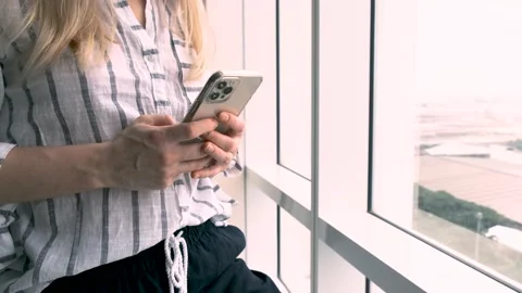 Woman using iPhone 12 pro max smartphone pressing finger, reading social media  Video stock 202087705