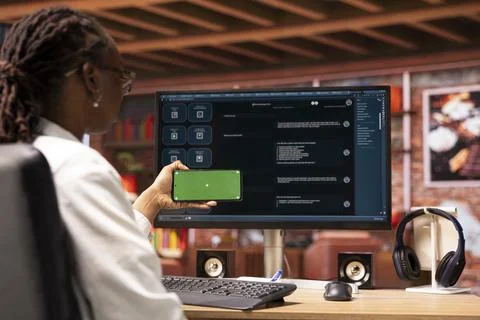 Woman using isolated screen smartphone and AI LLM chatbot on computer Stock Photos