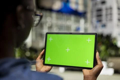 Woman using isolated screen tablet in city, close up Stockfoto's