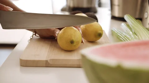 Woman Using Knife To Slice Lemon Stock Footage 141602039