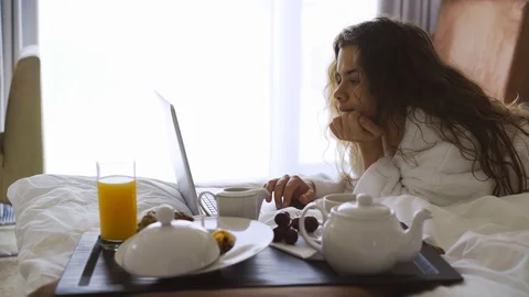 Woman using laptop in bed Stock Footage 111728285