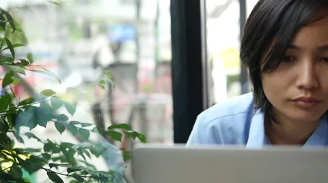 Woman using laptop in cafe Видео 68032662