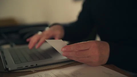 Woman using laptop computer and holding business card at desk, online busin.. Stock Footage 346078208