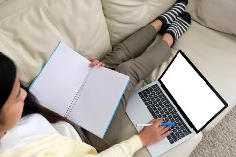 Woman using laptop computer with blank screen for mock up template background Stock Photos