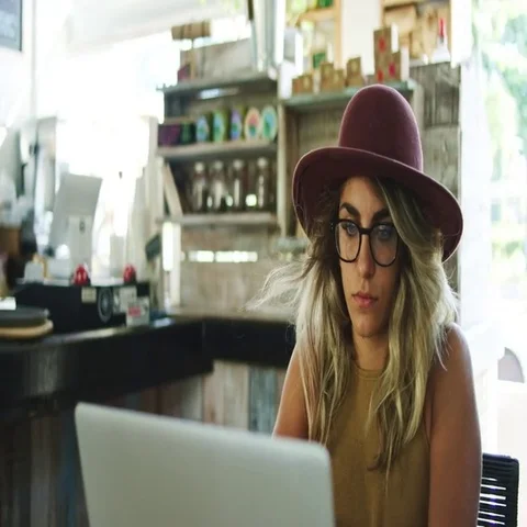 Woman using laptop computer in coffee shop Stock Footage 69382074