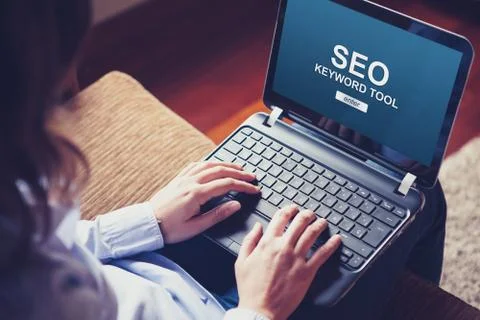 Woman using a laptop computer to do SEO positioning in a website. Stock Photos