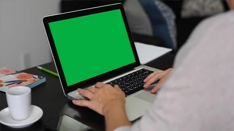 Woman using laptop computer with green screen Stock Footage 114775116