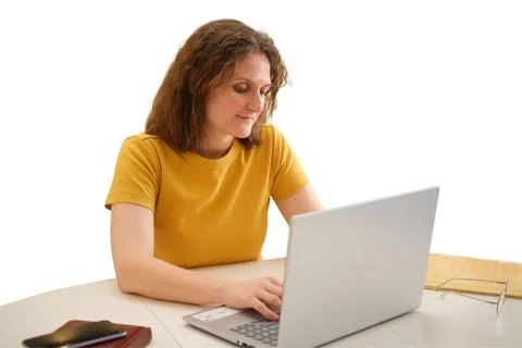 Woman using laptop computer at table. Caucasian woman surfing internet and wo 写真素材