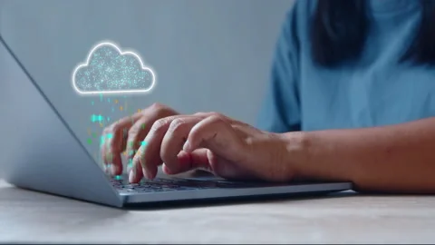 Woman using laptop with data being synchronized to cloud computing 스톡 동영상 342588633
