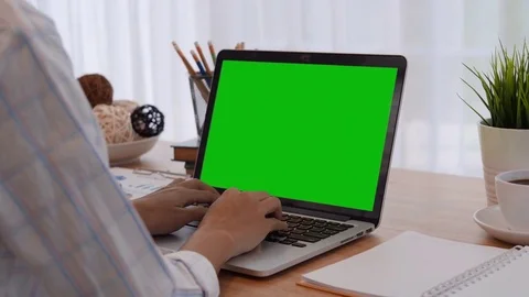 Woman using laptop Green Screen on table work place Stockbeeldmateriaal 81264751