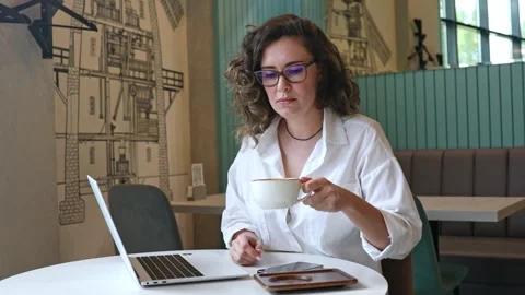 Woman using laptop pc computer, drink coffee, works in coffee shop, cafe Stock Footage 302155790