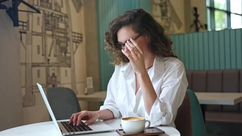 Woman using laptop pc computer, drink coffee, works in coffee shop, cafe Stock Footage 302155820