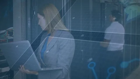 Woman using laptop, running network diagnostics; man checking racks and cables Stock Footage 332577591