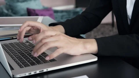 Woman using laptop at the table in office, young freelancer in modern Stock Footage