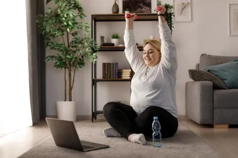 Woman using laptop while exercising 스톡 사진
