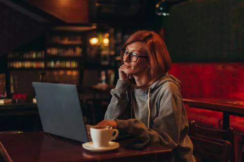 Woman using a laptop while working in a cafe Stock Photos