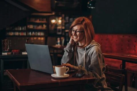 Woman using a laptop while working in a cafe Stock Photos