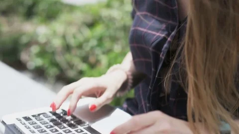 Woman Using a Laptop in the Wind. Camera Moving Up Stock Footage 77333020