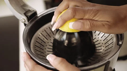 Woman Using Lemon Press In Kitchen Stock Footage 141602090
