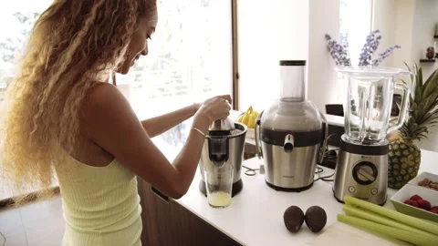 Woman Using Lemon Squeezer In Kitchen Stock Footage 141602469