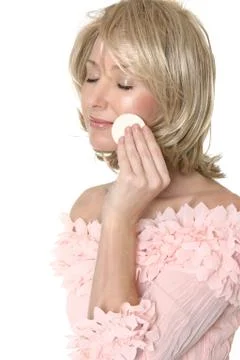 Woman using makeup applicator Stock Photos