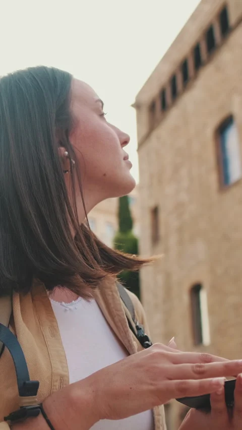 Woman using map app while standing on the square of an old european city Video stock 249731595