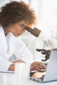 Woman using microscope in laboratory Foto stock