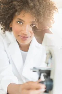 Woman using microscope in laboratory Stock Photos