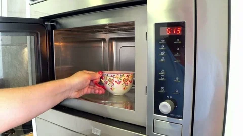 Woman using microwave oven Stock-Footage 80260739