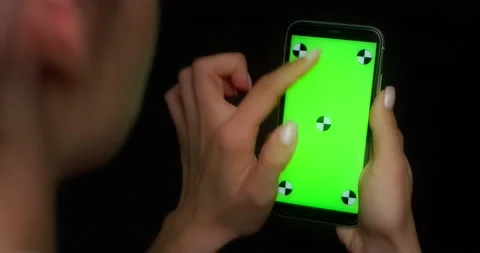 Woman using mobile app on green screen phone, swipes up Stock Footage 177242555