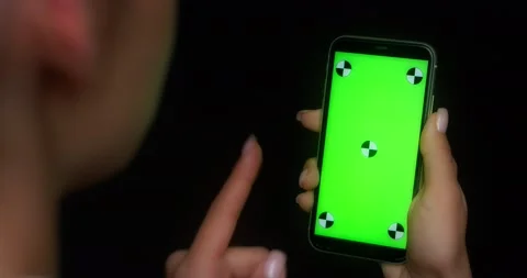 Woman using mobile app on green screen phone, swipes to the left Stock Footage 177243741