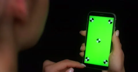 Woman using mobile app on green screen phone, swipes up Stock Footage 177777958