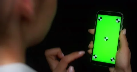 Woman using mobile app on green screen phone, swipes up Stock Footage 177778607