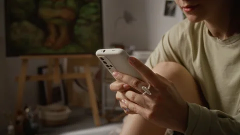 Woman Using Mobile Application on Smartphone in Studio Stock Footage 345225236