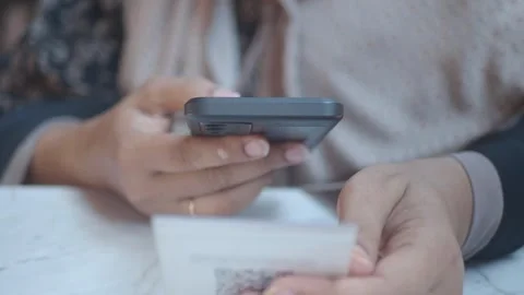 Woman using a mobile device  to scan QR code for cafe menu Stock Footage 315144556