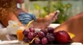 Woman Using Mobile Phone and Enjoying Fresh Fruits near Swimming Pool. HD Footage